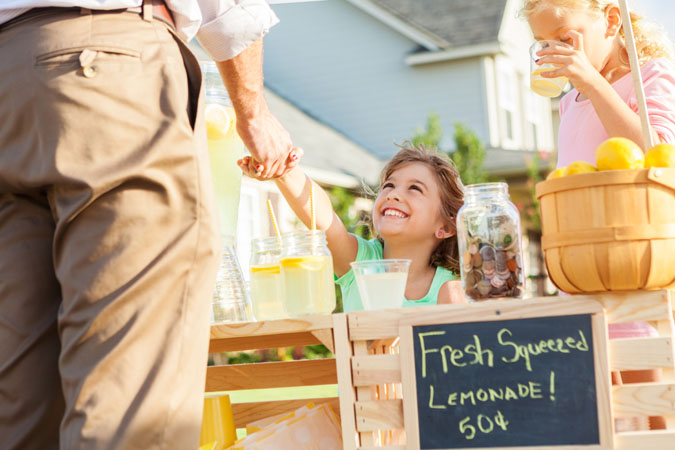 A child greets a potential investor for their lemonade business